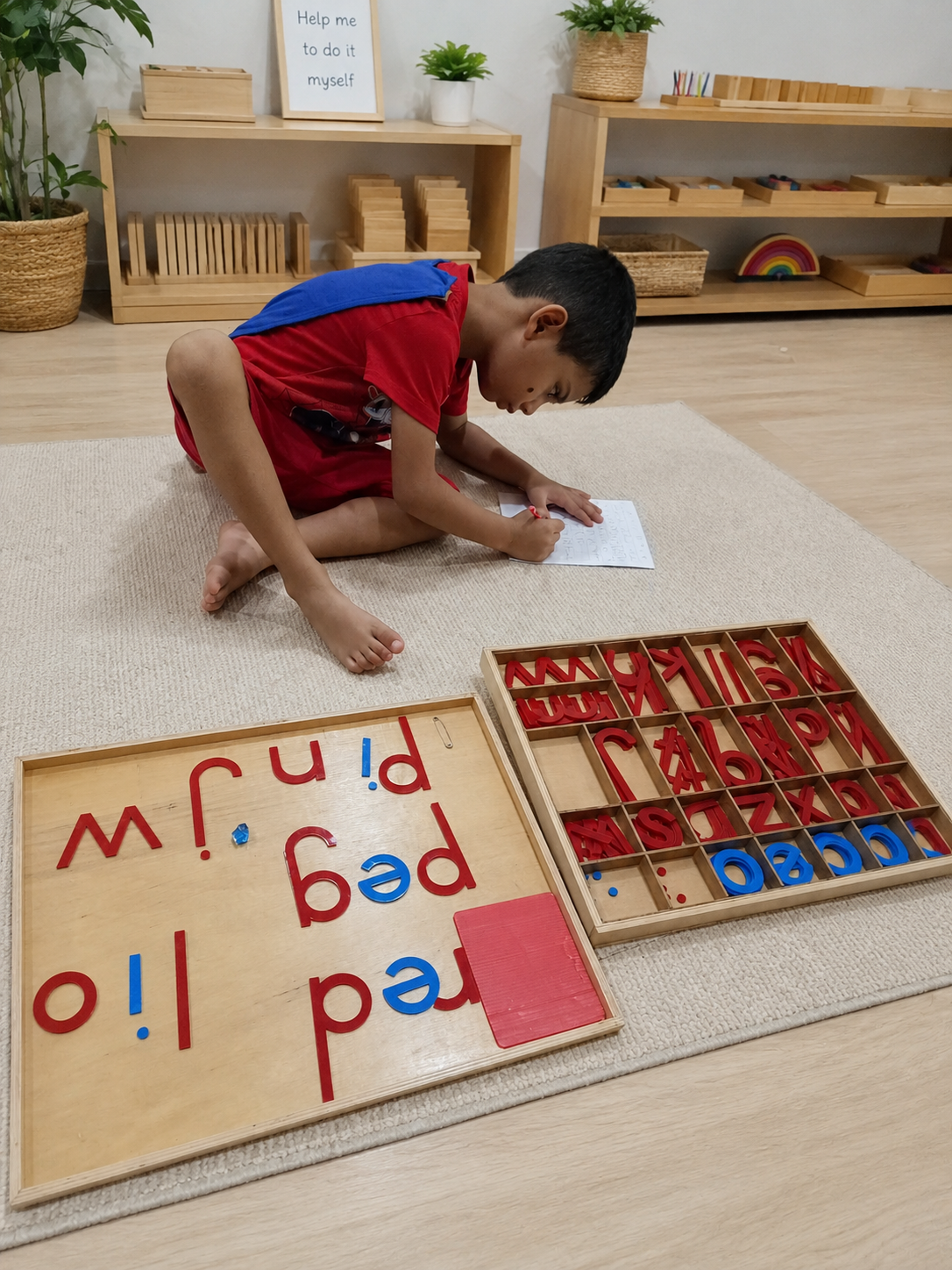 Lishaan sounding out and blending letters with the Montessori Large Moveable Alphabet
